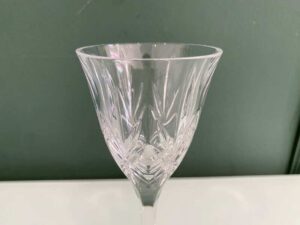 Crystal wine glass with a fan-shaped faceted pattern.