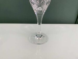 Crystal wine glass with a fan-shaped faceted pattern.