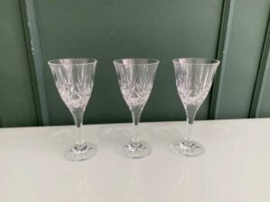 Crystal wine glass with a fan-shaped faceted pattern.