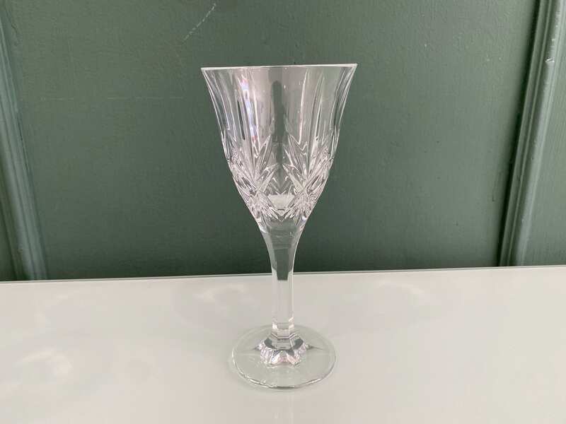 Crystal wine glass with a fan-shaped faceted pattern.
