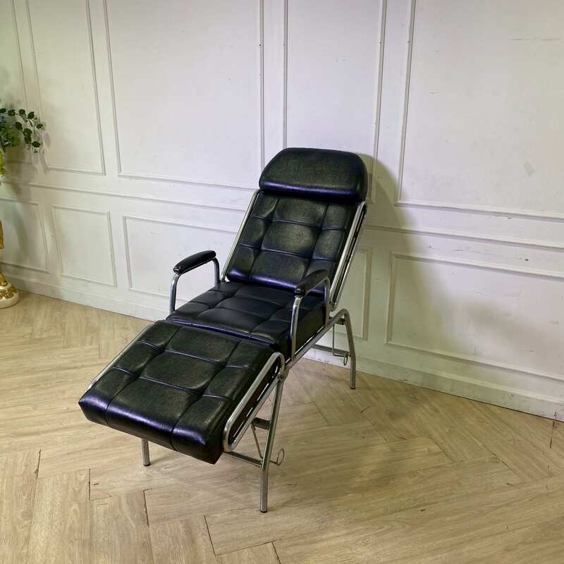 Facial massage bed, steel legs, black leather upholstery.