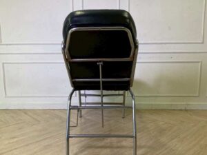 Facial massage bed, steel legs, black leather upholstery.