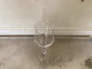 Clear wine glass, shaped like a flower.