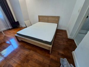5-foot wooden bed, light brown, minimalist style.