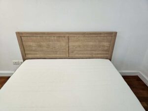 5-foot wooden bed, light brown, minimalist style.
