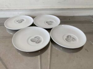 White ceramic coffee cup set with handle and saucer, Costa Coffee brand.