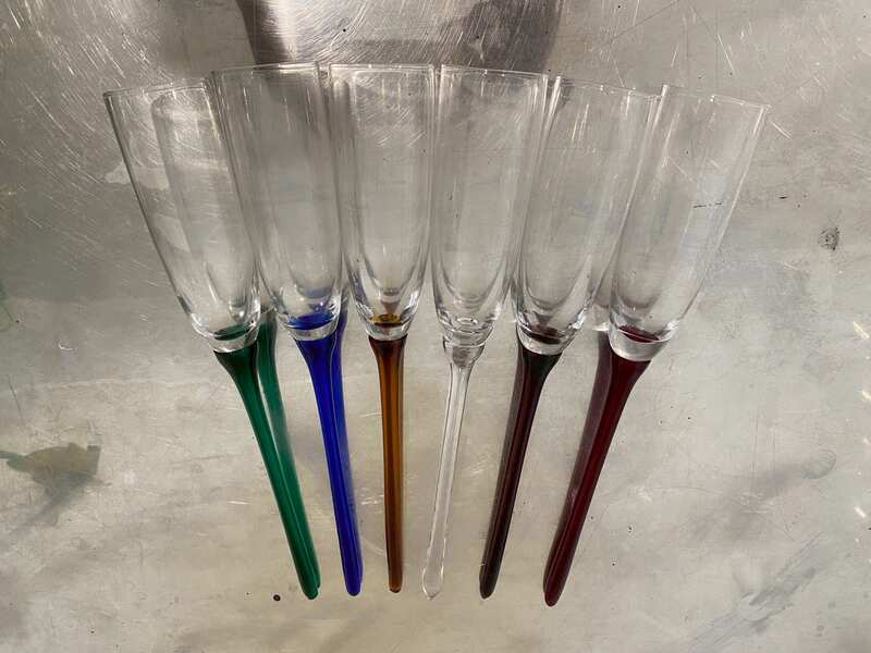 Vintage bohemian-style champagne glasses, tall with no base, long stems in various colors.