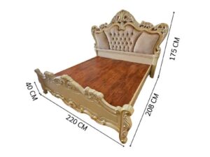 6-foot Louis XV bed with beige nude velvet headboard and carved floral frame.