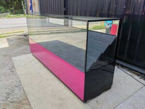 230 cm LED Glass Display Counter with Pink–Black Base and Tiered Shelves