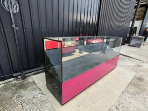 230 cm LED Glass Display Counter with Pink–Black Base and Tiered Shelves