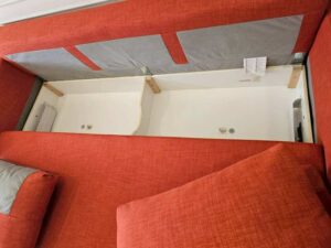 3-seater sofa bed, fabric upholstery, red-orange color, with under-seat storage.