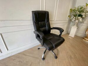 Office chair with massage function, black leather upholstery.