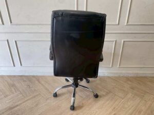 Office chair with massage function, black leather upholstery.