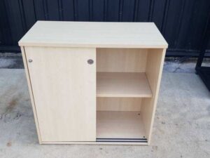 Cream-colored, wooden-framed filing cabinet with 2 sliding doors.