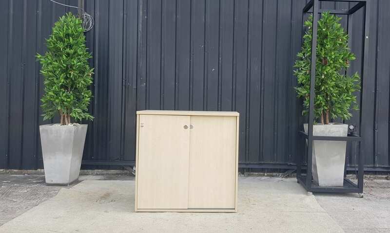 Cream-colored, wooden-framed filing cabinet with 2 sliding doors.