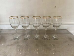 Standard-shaped wine glass with gold rim.