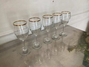 Standard-shaped wine glass with gold rim.