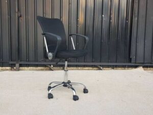 Office chair, fabric upholstery, mesh backrest, steel legs, black color.