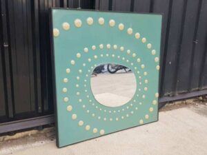 Dotted wall mirror with green background, square shape