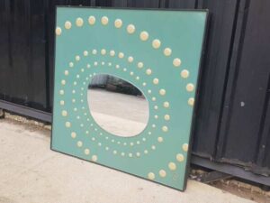 Dotted wall mirror with green background, square shape