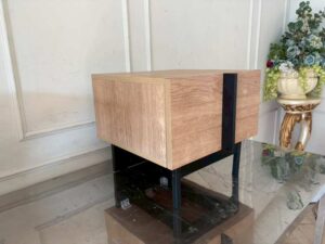 Modern style wooden bedside table set with black iron legs.