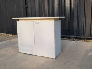 Two-door filing cabinet with wide wooden top, white color.