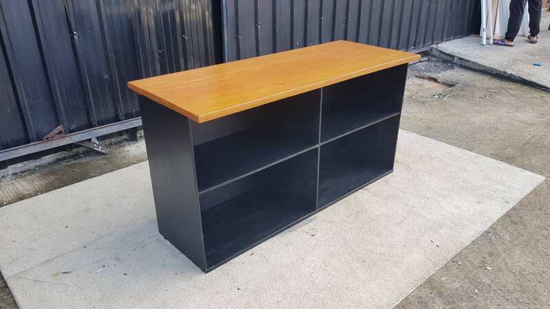 4-shelf black shelf with cream-colored wood top and plywood.