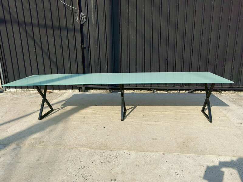 Conference table with glass top and black steel legs, 350 cm.