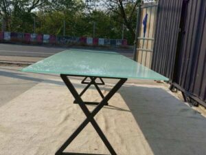 Conference table with glass top and black steel legs, 350 cm.