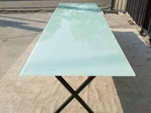 Conference table with glass top and black steel legs, 350 cm.