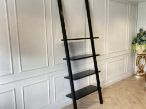Black wooden ladder-shaped shelving unit
