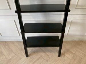 Black wooden ladder-shaped shelving unit