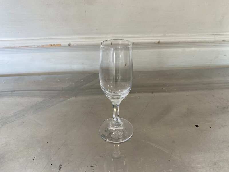 Clear stemmed wine glass, tall and slender.
