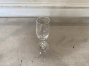 Clear stemmed wine glass, tall and slender.