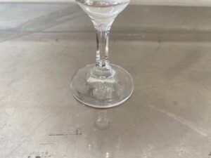 Clear stemmed wine glass, tall and slender.
