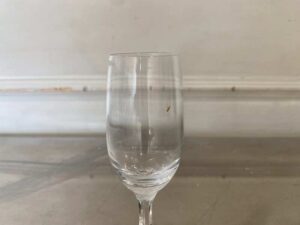Clear stemmed wine glass, tall and slender.