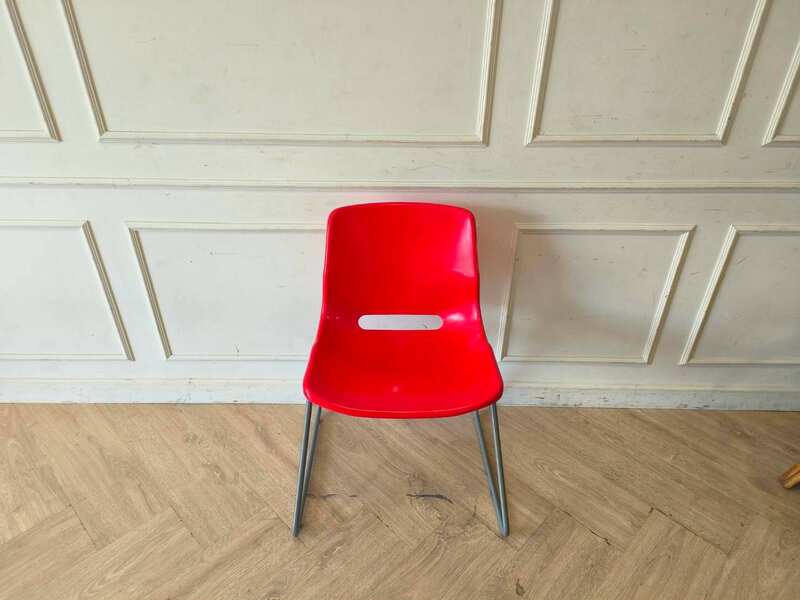 Plastic chair with metal legs, IKEA brand, SNILLE model.