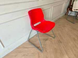 Plastic chair with metal legs, IKEA brand, SNILLE model.