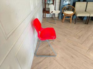 Plastic chair with metal legs, IKEA brand, SNILLE model.