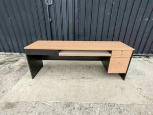 Black L-shaped corner desk with brown wood-tone top; modular/separable
