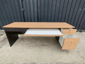 Black L-shaped corner desk with brown wood-tone top; modular/separable