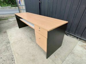 Black L-shaped corner desk with brown wood-tone top; modular/separable