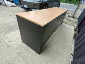 Black L-shaped corner desk with brown wood-tone top; modular/separable
