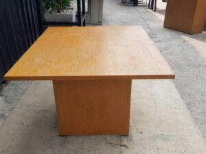 4-seat conference table with wooden legs, brown.