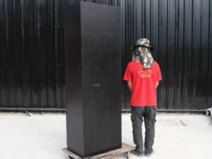 Tall wooden cabinet with 4 doors, opens to the left, black, has storage compartments inside._JRJSD6JFML