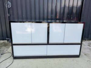 Glass Retail Display Counter with White Tiered Shelves, LED Lighting, and a Glossy Black Base