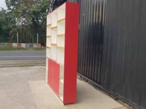 Wooden shelving unit with 2 sliding doors and 13 compartments, white and red.