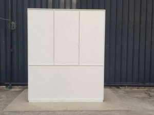 Wooden shelving unit with 2 sliding doors and 13 compartments, white and red.