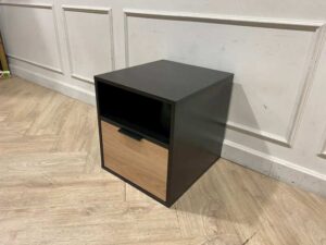 Black wooden cabinet with 1 drawer and 1 storage compartment.