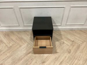 Black wooden cabinet with 1 drawer and 1 storage compartment.
